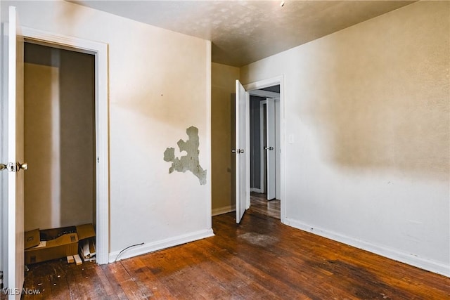 spare room with dark hardwood / wood-style floors