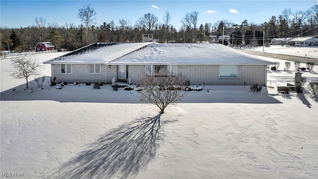 view of snow covered back of property