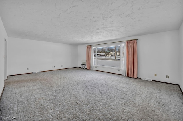 carpeted spare room featuring a textured ceiling