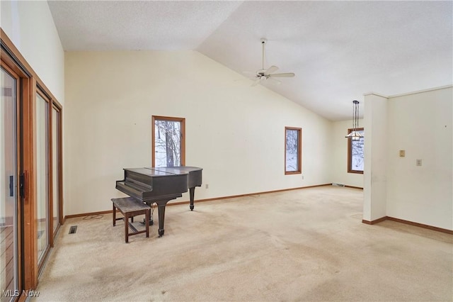 carpeted living room with vaulted ceiling, ceiling fan, and plenty of natural light