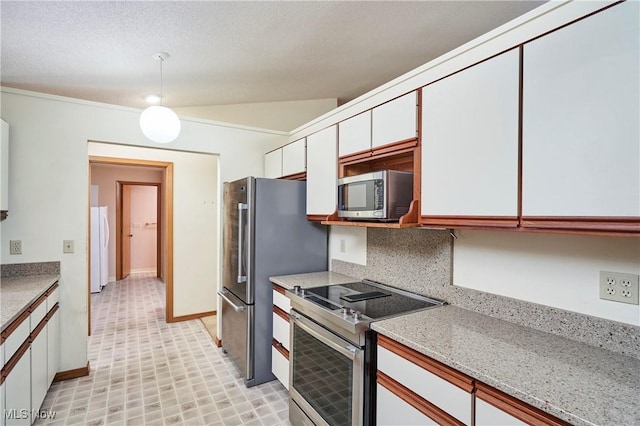 kitchen featuring stainless steel appliances, white cabinetry, vaulted ceiling, tasteful backsplash, and light stone countertops