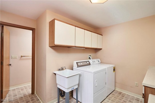 washroom featuring independent washer and dryer, cabinets, and sink