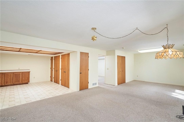 basement featuring light colored carpet