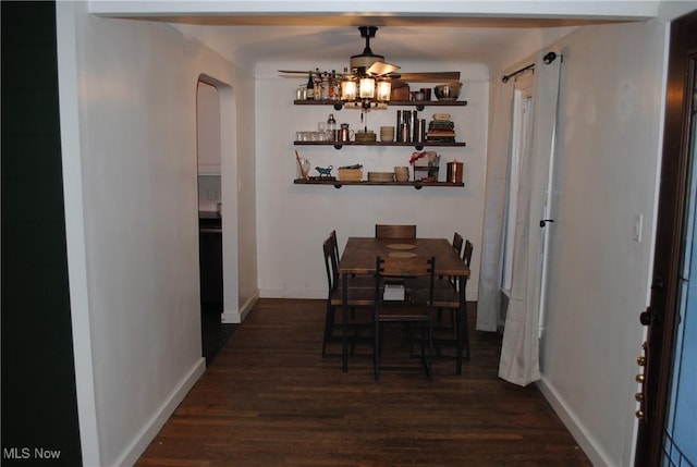 dining space featuring dark wood-type flooring and ceiling fan