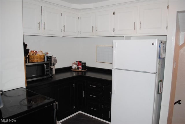 kitchen with black appliances and white cabinets