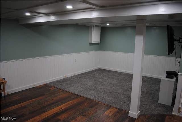 basement with dark hardwood / wood-style flooring