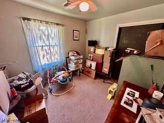 interior space with ceiling fan and carpet