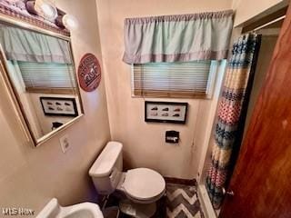 bathroom with walk in shower and toilet