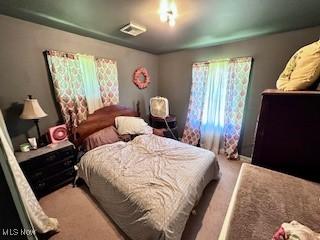 bedroom featuring light colored carpet