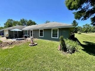 rear view of property featuring a lawn