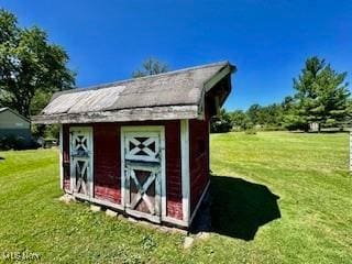 view of outbuilding featuring a lawn