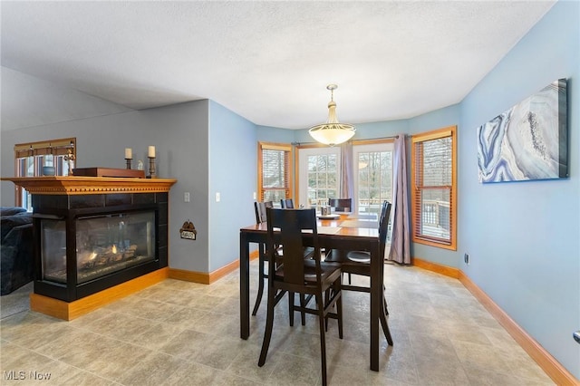 dining space featuring a tiled fireplace