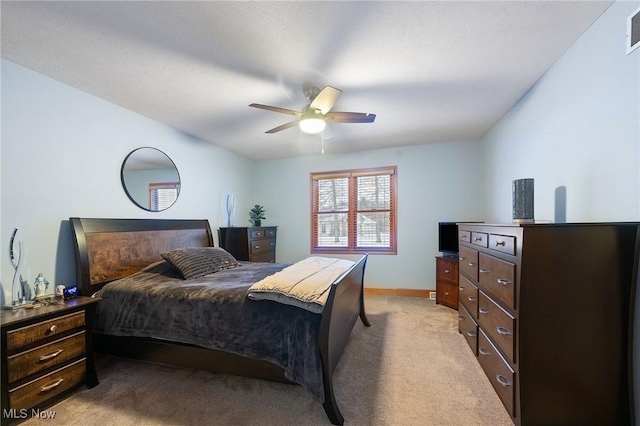 bedroom with ceiling fan and light carpet