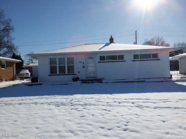 view of snow covered back of property