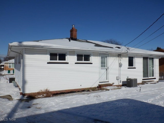 snow covered property featuring central air condition unit