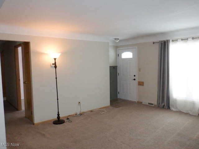 entrance foyer featuring light carpet