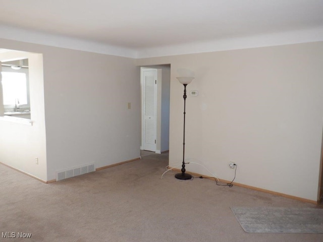 carpeted spare room featuring sink