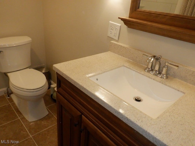 bathroom featuring tile patterned flooring, vanity, and toilet