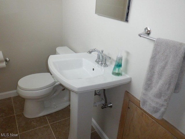 bathroom featuring toilet and tile patterned floors