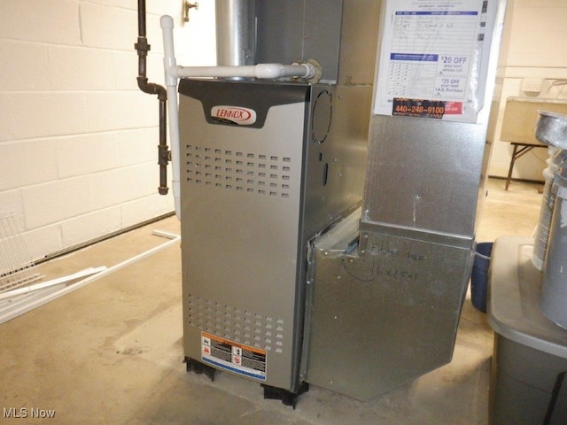 utility room featuring heating unit