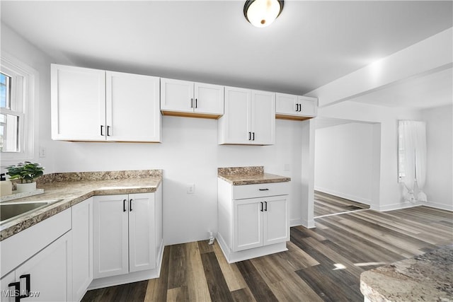 kitchen featuring sink, dark hardwood / wood-style floors, and white cabinetry