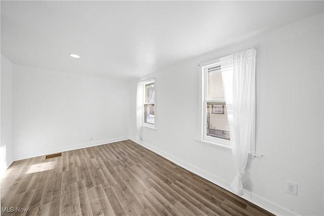 unfurnished room featuring hardwood / wood-style floors