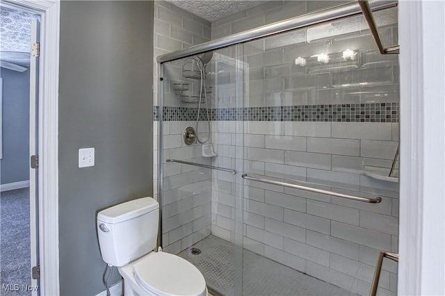 bathroom featuring toilet and an enclosed shower