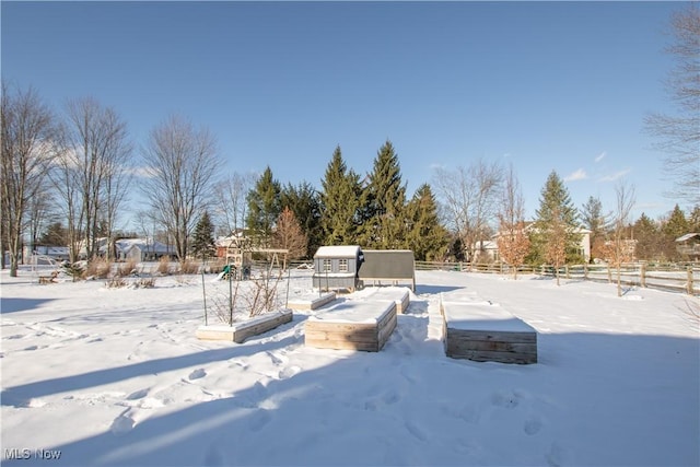 yard layered in snow featuring a playground