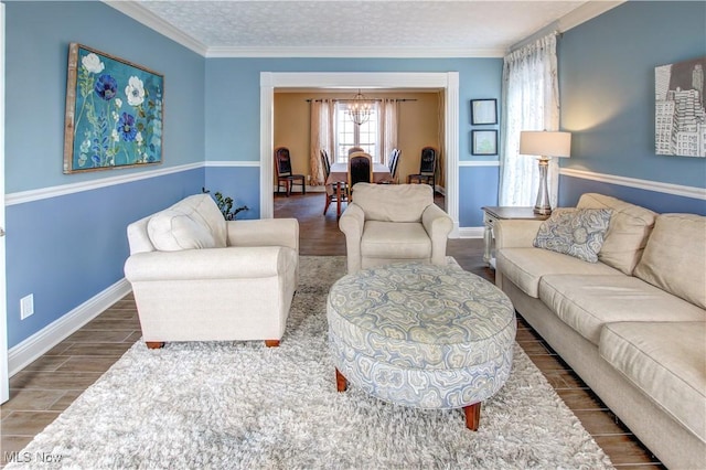 living room with dark hardwood / wood-style flooring, an inviting chandelier, and crown molding