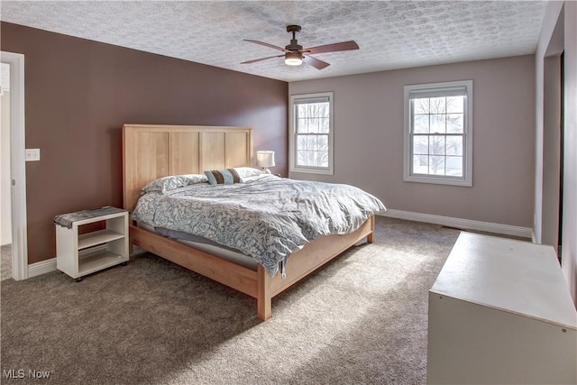 carpeted bedroom with a textured ceiling and ceiling fan