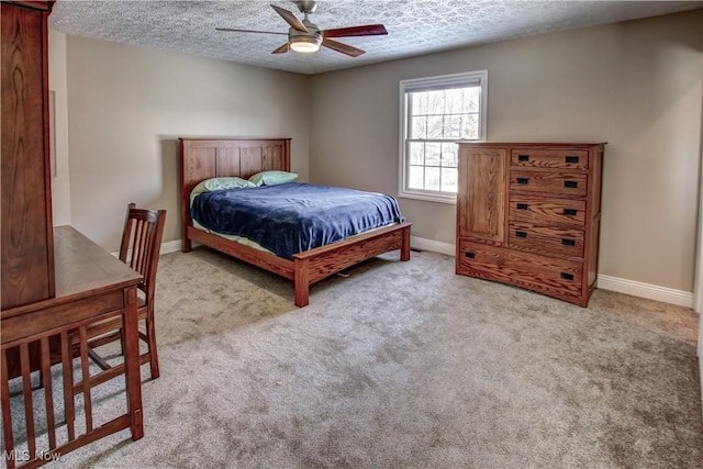 carpeted bedroom with a textured ceiling and ceiling fan