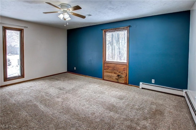 unfurnished room featuring ceiling fan, carpet flooring, a textured ceiling, and baseboard heating