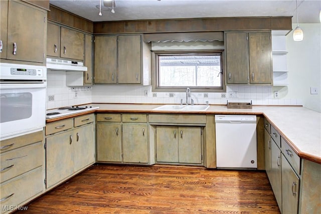 kitchen featuring tasteful backsplash, sink, dark hardwood / wood-style flooring, hanging light fixtures, and white appliances