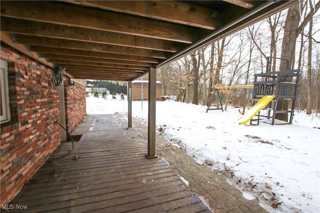 snow covered deck with a playground