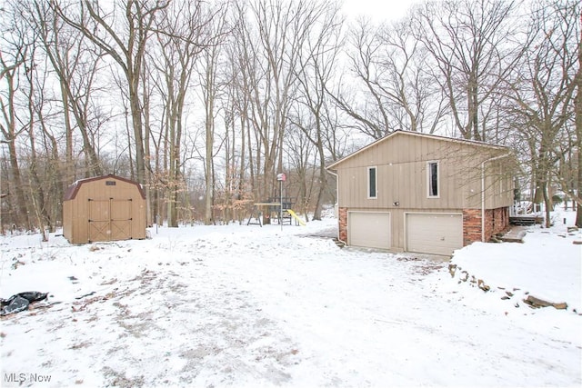 view of snow covered exterior with a garage