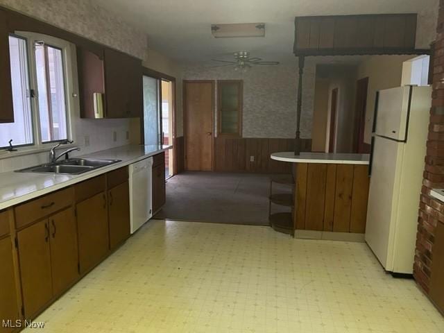 kitchen with white appliances, ceiling fan, and sink