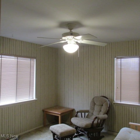 sitting room featuring ceiling fan and carpet flooring