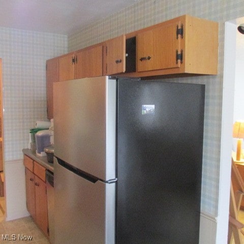 kitchen with stainless steel fridge and dishwasher