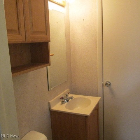 bathroom with vanity and toilet