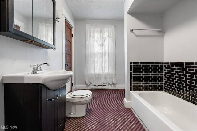 bathroom with toilet, a washtub, a textured ceiling, and vanity