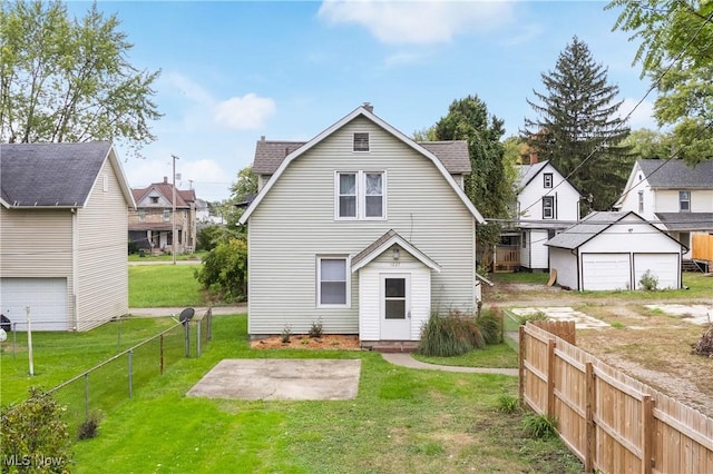 back of property with a yard and a patio