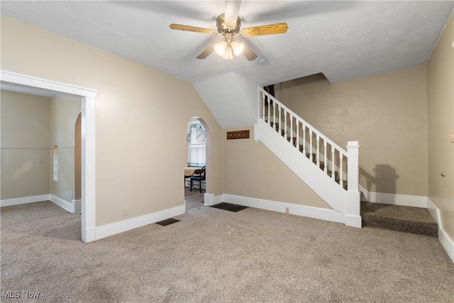 unfurnished living room featuring lofted ceiling, carpet floors, and ceiling fan