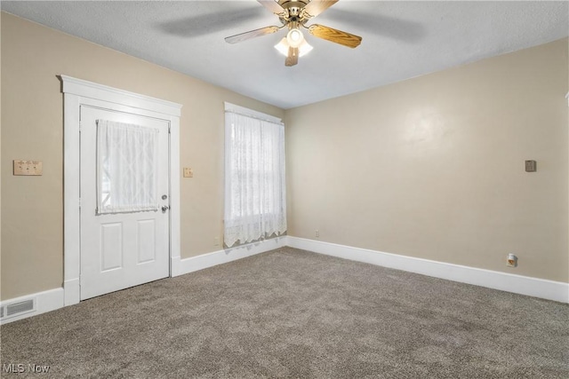 carpeted foyer with ceiling fan