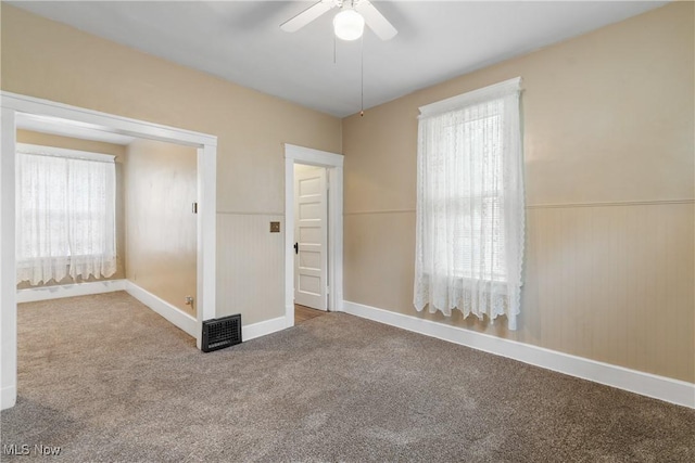 unfurnished bedroom featuring carpet floors, ceiling fan, and multiple windows