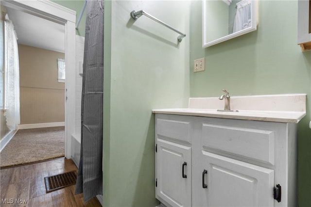 bathroom with vanity, bathtub / shower combination, and hardwood / wood-style floors