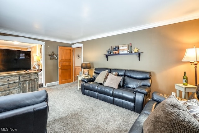 carpeted living room featuring ornamental molding