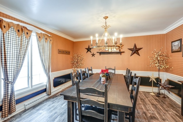 dining room with baseboard heating, an inviting chandelier, crown molding, and dark wood-type flooring