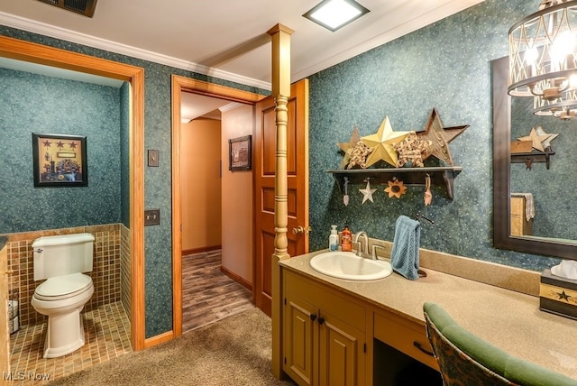 bathroom featuring toilet, ornate columns, crown molding, and vanity