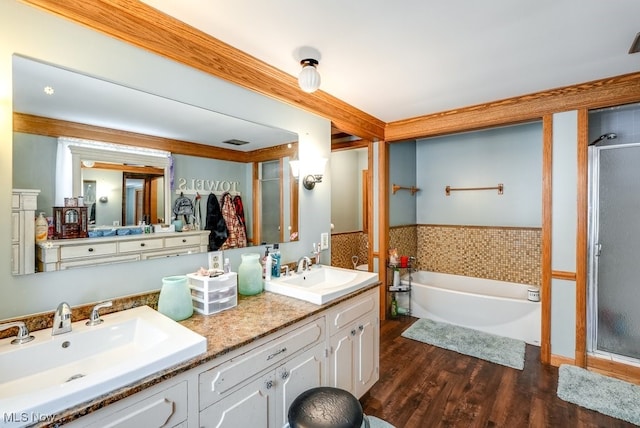 bathroom with shower with separate bathtub, vanity, and hardwood / wood-style floors