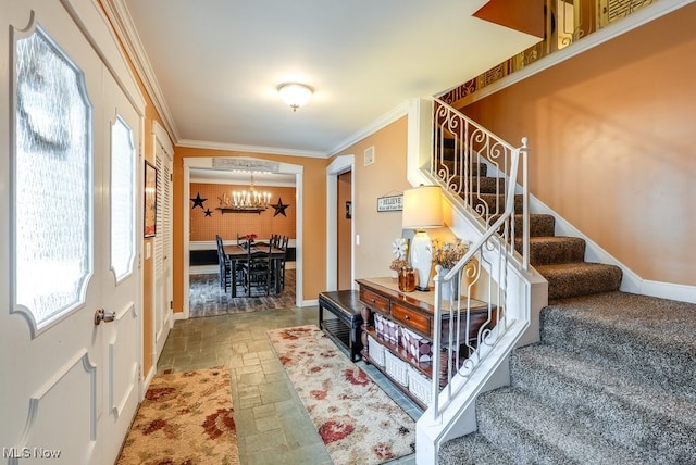 entrance foyer featuring ornamental molding and a notable chandelier